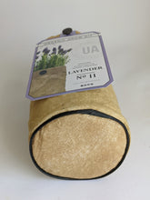Load image into Gallery viewer, Organic lavender grow kit bag shown from the bottom to show that the bottom is round with black piping as trim for stability. This bag contains everything you need except the water and sunshine to get your herbs growing right in the bag.