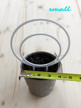 Cargar imagen en el visor de la galería, Small, white, double hoop trellis shown in 4 inch pot for scale. Tape measure shows size of pot. Hoop is 5.5 inches.
