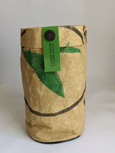 Load image into Gallery viewer, Basil organic grow kit includes soil and seeds to be grown in the bag pictured here. It is a recycled seed sack, tan in color with the printing visible that once told what the original bag held. 
