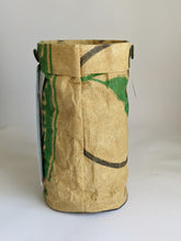 Load image into Gallery viewer, Basil organic grow kit includes soil and seeds to be grown in the bag pictured here. It is a recycled seed sack, tan in color with the printing visible that once told what the original bag held.
