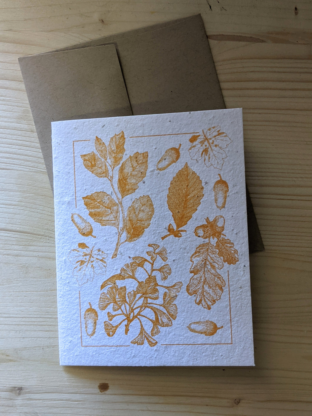 Plantable seed card greeting card with detailed orange ink printed acorns and leaves comes with this brown envelope as shown. Beautifully textured, white seed paper gives a handcrafted, high end look and feel. 