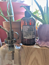 Cargar imagen en el visor de la galería, Succulent, cacti, and aloe fertilizer sits next to aloe plants on sunny plant shelf, and next to a glass and chrome mister bottle. 
